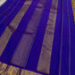 Indigo Vanki Ilai Butta – steel-lilac body with royal-blue korvai borders

Pure Kanchipuram silk • scattered gold ilai (leaf) buttas on a dual-tone base

Royal-blue brocade pallu with multi zari stripes & bold chevron (vanki) panels • contrast blouse