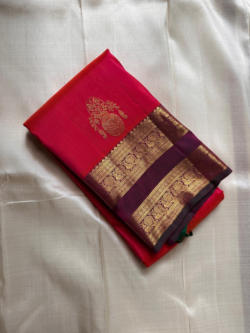 Rani Kalash – Pure Silk Kanchipuram Saree
Vibrant Rani Pink Body with Kalash Zari Buttas ✨
Deep Plum Korvai Borders in Lustrous Gold Weave
Grand Antique-Gold Brocade Pallu with Temple Elegance
Silk Mark Certified | ships in 2 weeks
