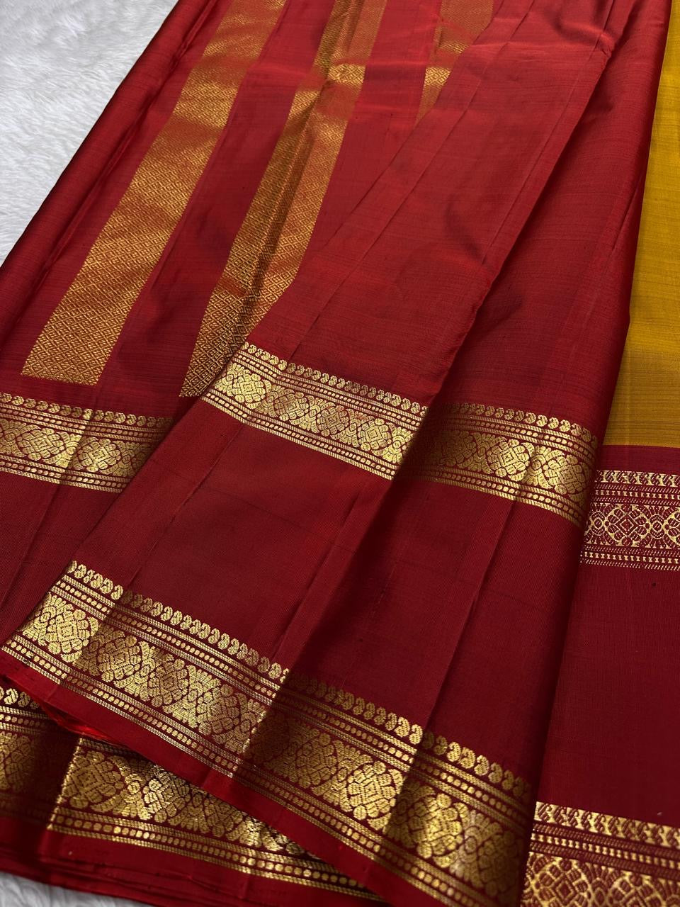 Ponvandu Kumkumam – Pure Kanchipuram Silk Saree
Honey-Gold Body with Zari Buttas
Contrasting Kumkum Red Borders with Floral Zari
Grand Kumkum Red Pallu with Zari Kaddi & Brocade
Silk Mark , | ships in 2 weeks, fall pico | Blouse Stitching Available |