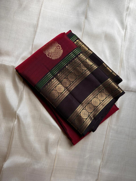 Ishwaryam ❤️🕊️✨

Ruby  Red Handwoven Kanchipuram Silk Saree with Majestic Gandaberunda Zari Adai Motif 🕊️🌟

Ornate Rettapet Border with Delicate Kamalam Seer Floral Detailing 🌺🪡

Deep Coffee Brown Pallu Adding Warmth and Elegant Contrast ☕🌿