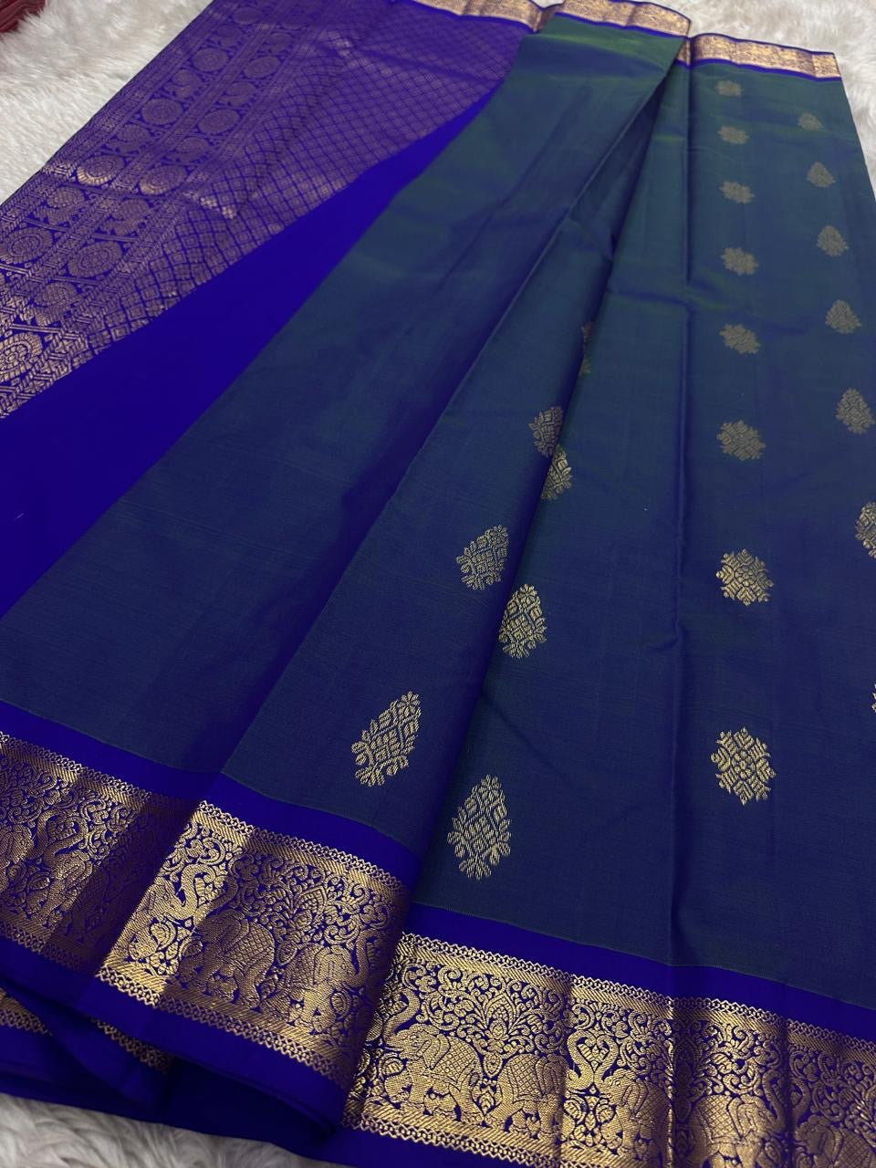 Swaram Lightweight – Peacock Dusk Blue
Feather-Light Peacock Blue Kanchipuram Silk Saree
Elephant & Tree of Life Zari-Woven Grandeur