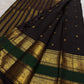 Thogai Mayil plume-style ornamental zari woven along the layered gold border of the deep brown × bottle green saree