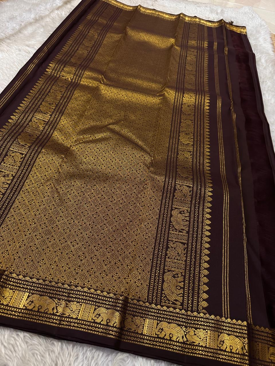 Ember ✨
Pure Kanchipuram Silk Saree in Ember Red & Coffee Brown
Ember-red body with delicate gold zari buttas
Rich coffee-brown elephant border with zari vines

Silk Mark Certified, delivery in 2 weeks
