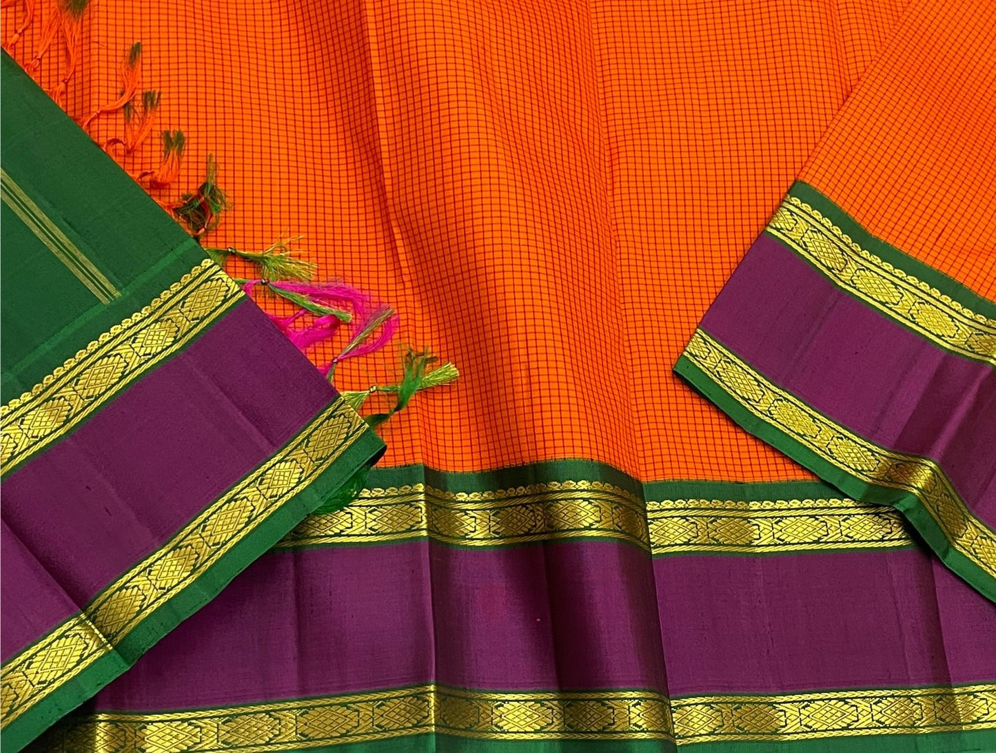 Sunset Kattam — Pure Kanchipuram Silk Saree
Sunset-orange kattam body with royal purple borders and emerald green pallu in fine zari.
Silk Mark Certified • Free Shipping within USA • Ships in Two Weeks