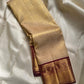 Ragini – Ivory & Gold Kanchipuram Pure Silk Saree with Floral Jaal & Maroon Baavanji Border
Timeless elegance shines through the delicate ivory base and shimmering gold zari floral jaal. The rich maroon Baavanji border and intricate pallu details complete