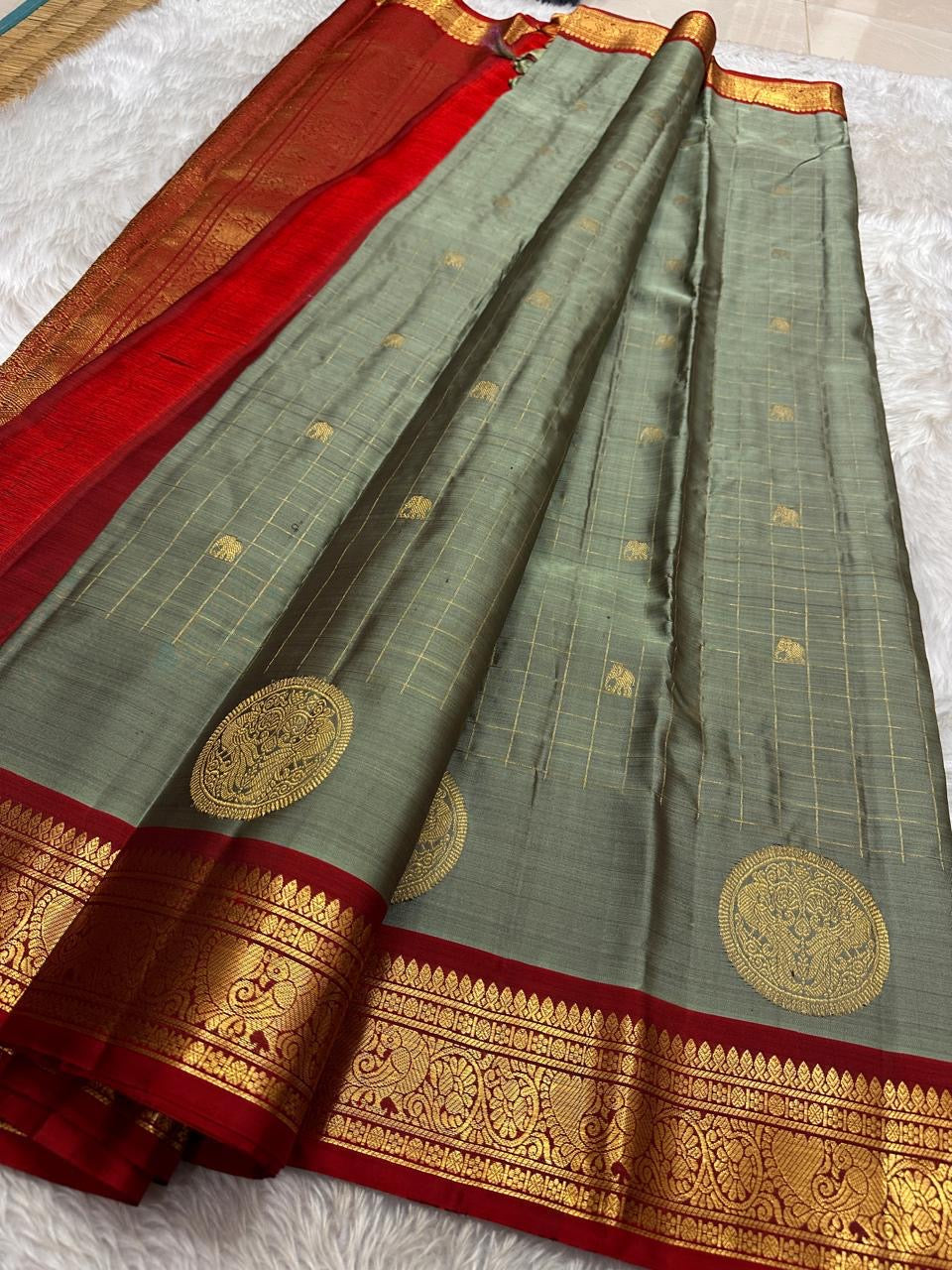 Sorgavaasal Kili , stunning motif in  golden dove grey and red zari kattam zari woven yazhi buttas in pure silk kanchipuram