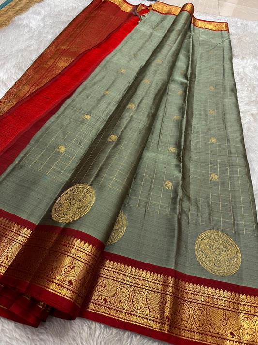 Sorgavaasal Kili , stunning motif in  golden dove grey and red zari kattam zari woven yazhi buttas in pure silk kanchipuram