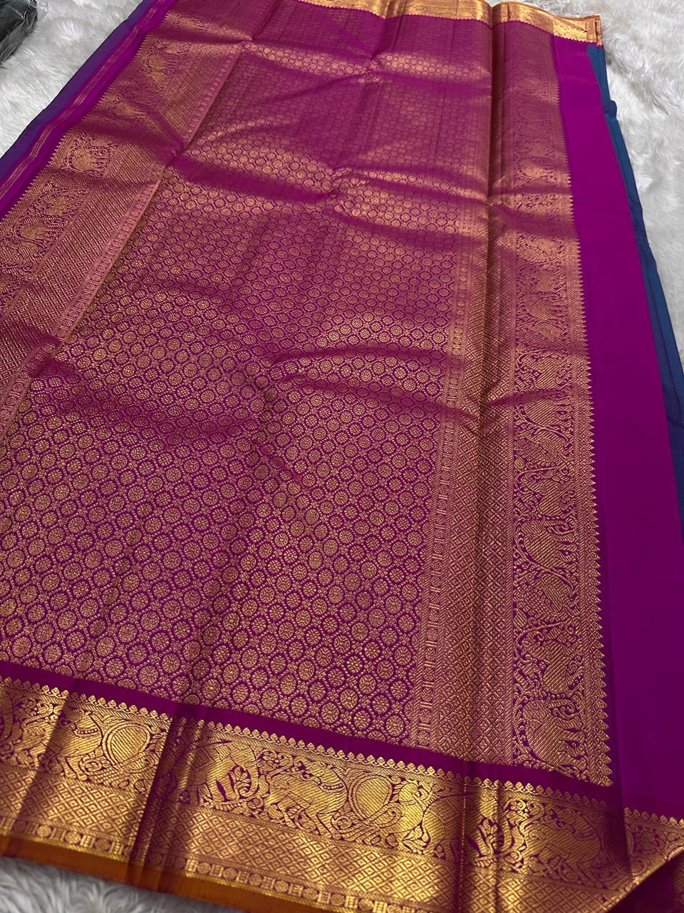 Lotus Crest Blue — Pure Kanchipuram Silk Saree Peacock–blue body with gold buttas & magenta elephant zari-woven borders Silk Mark Certified • Free Shipping within USA • Ships in Two Weeks
