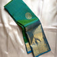 Parrot green silk saree with zari medallion butta and sky blue border, folded display