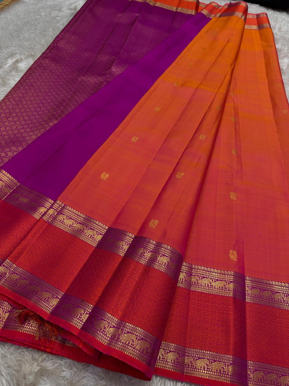 Suryarekha – Pure Korvai Kanchipuram Silk Saree
Kesari-Orange & Pink dual-tone body with gold paisley buttas
Arakku Red korvai border with diamond brocade elephant  motifs
Vadamalli Purple grand zari brocade pallu | shios in 2 weeks ,silk mark cer
