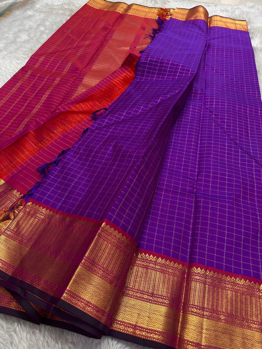 Amethyst Zari Kattam – Pure Kanchipuram Silk Saree
Rich Amethyst Purple Body with Golden Zari Checks
Broad Gold Zari Border with Red Highlights & Temple Motifs
Radiant Ruby Red-Orange Pallu with Lustrous Zari Stripes

Silk Mark Certified, delivery in 2 we