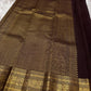 Kavi — oosi  kattam Pure Kanchipuram Silk Saree

Burnt Orange (saffron–rust) body
Deep coffee-maroon contrast border with grand antique-gold zari
Rich brocade pallu; peacock & floral vines in the border
Silk Mark Certified