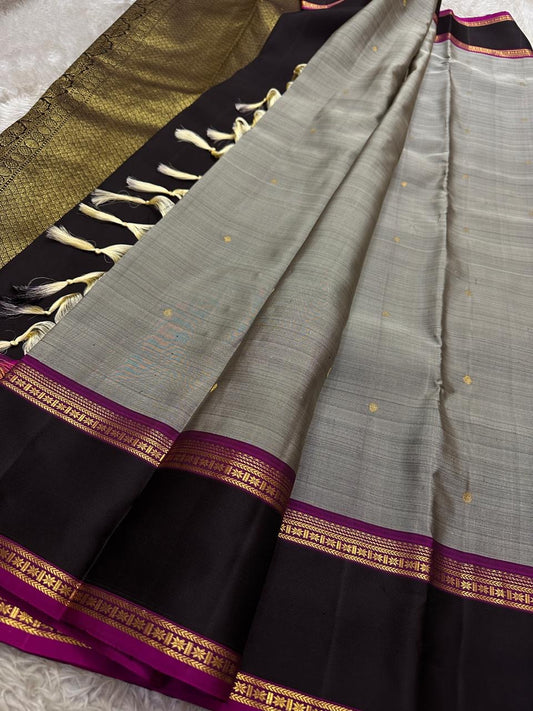 Ash Gulabi Chakram — Pure Kanchipuram Silk Saree
Elegant ash-grey body with gold zari chakram buttas, rich gulabi korvai borders, and deep violet zari pallu.
Silk Mark Certified • Blouse Stitching Available ($30) • Free Shipping within USA • 2 weeks