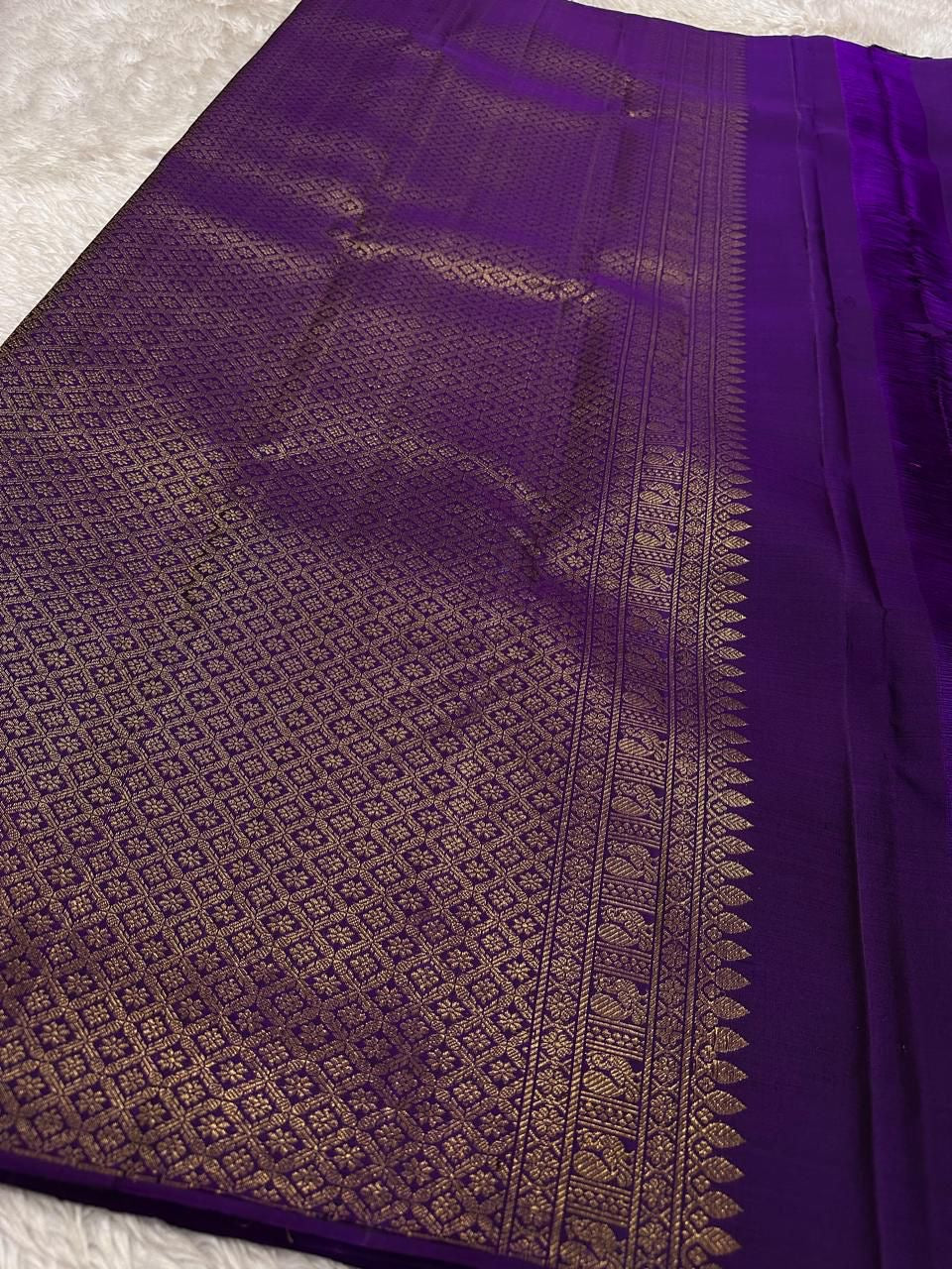 Lotus Glow — Violet | Pure Kanchipuram Silk Saree
A royal violet canvas with antique-gold zari peacocks, elephants & lotus motifs ✨
Silk Mark Certified • Free USA Shipping • Ships in Two Weeks
