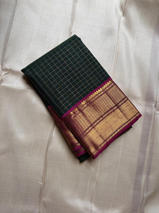 Pachai Zari Kattam – Pure Kanchipuram Silk Saree
Deep Emerald Green Body with Gold Zari Checks
Broad Golden Border with Magenta Highlights & Temple Motifs
Royal Magenta Pallu with Lustrous Zari Stripes

Silk Mark Certified, delivery in 2 weeks