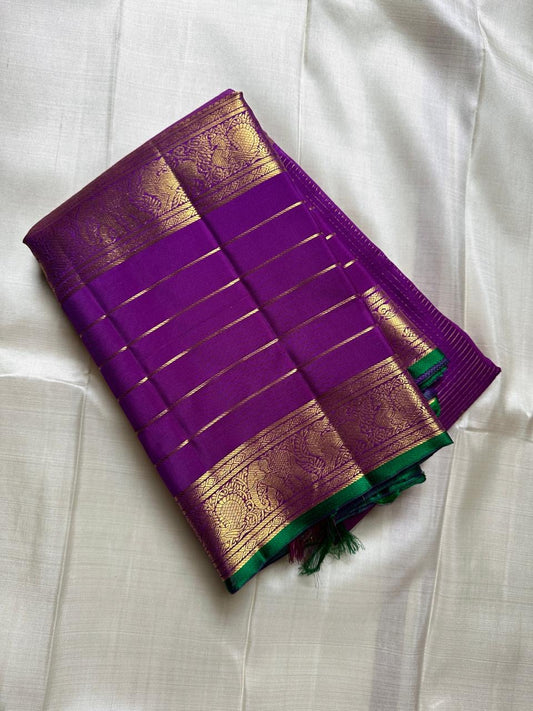 Kiran ✨ – Pure Kanchipuram Silk Saree
Regal Purple Body with Zari Kattam & Buttas
Classic Rettapet Border in Gold Zari Stripes
Intricate Heirloom-Inspired Zari Pallu
Accented with Contrast Green Selvedge Silk Mark Certified, delivery in 2 weeks