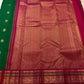 Wide magenta Varisaipet border with dense gold zari bands and Kili Yazhi motif panels on emerald Kanchipuram silk