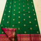 Emerald green and magenta Kanchipuram Varisaipet saree folded flat — full length view