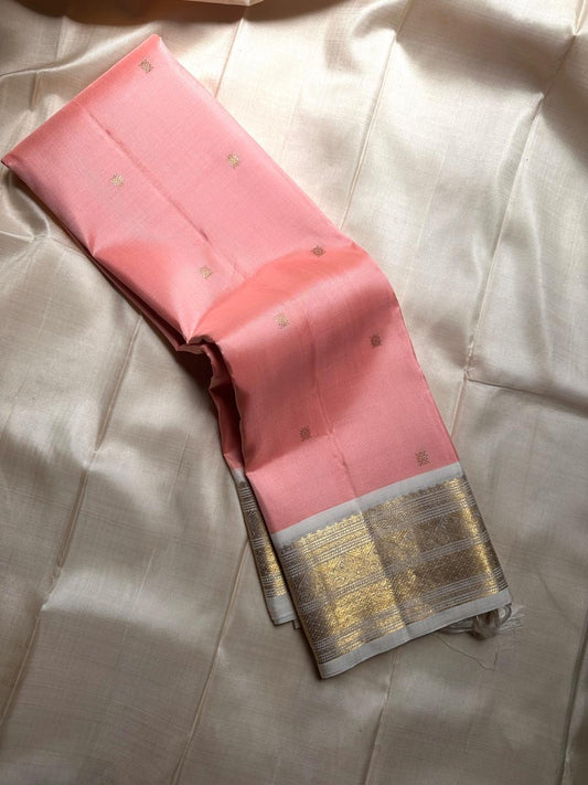 A serene blend of blush pink and pure white — soft, graceful pure silk Kanchipuram with kamalam zari butta and bavanji border and Pallu in cream