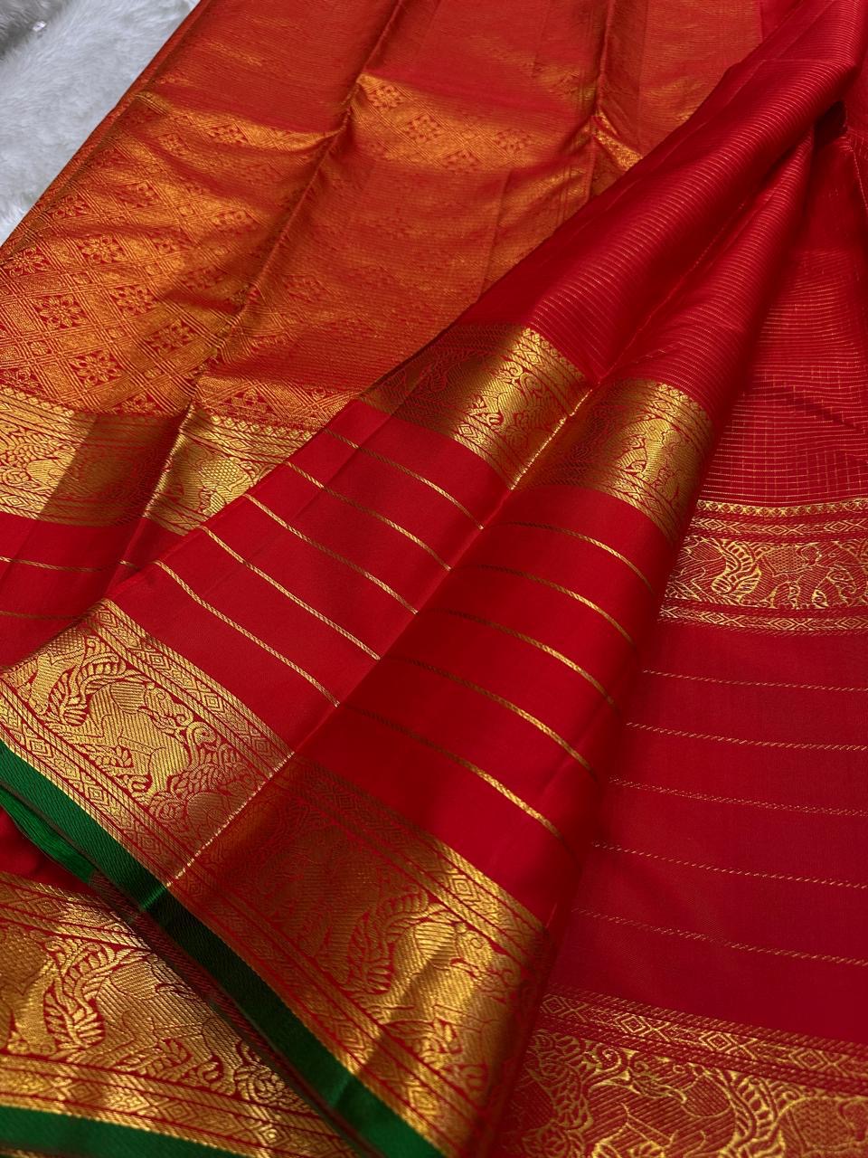 Aruna Kiran Red — Pure Silk Kanchipuram Saree
Crimson body with gold pinstripes, coin buttas & elephant zari borders
Silk Mark Certified • Free USA Shipping • Ships in Two Weeks