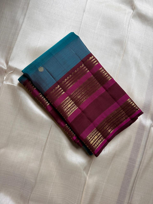 Neelam Jamuna – Pure Kanchipuram Silk Saree

A teal body adorned with glowing zari buttas.

Wine korvai border detailed with antique-gold.

A majestic jamuna pallu rich in brocade artistry.

Silk Mark Certified, delivery in 2 weeks