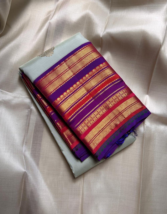 Kumari ✨ – Pastel Sage Green Kanchipuram Pure Silk Saree
with Delicate Golden Floral Buttas 🌸
Purple–Red Korvai Varisaipet Zari Border
Grand Purple Pallu with Stripes & Floral Vines
An Heirloom of Grace, Heritage & Festive Splendor