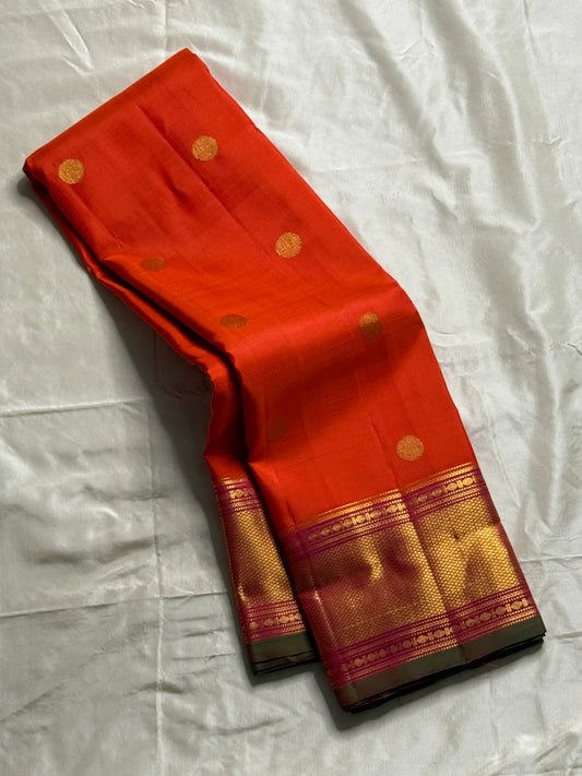 Kalpana  
Pure Silk Kanchipuram Saree  
Burnt Orange with Golden Buttas  
Intricate Magenta & Gold Zari Border