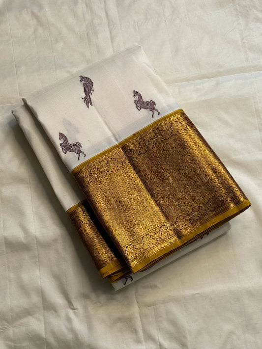 Close-up of Ashwa Pakshi ivory Kanchipuram silk saree showing horse and parrot motifs with gold zari border