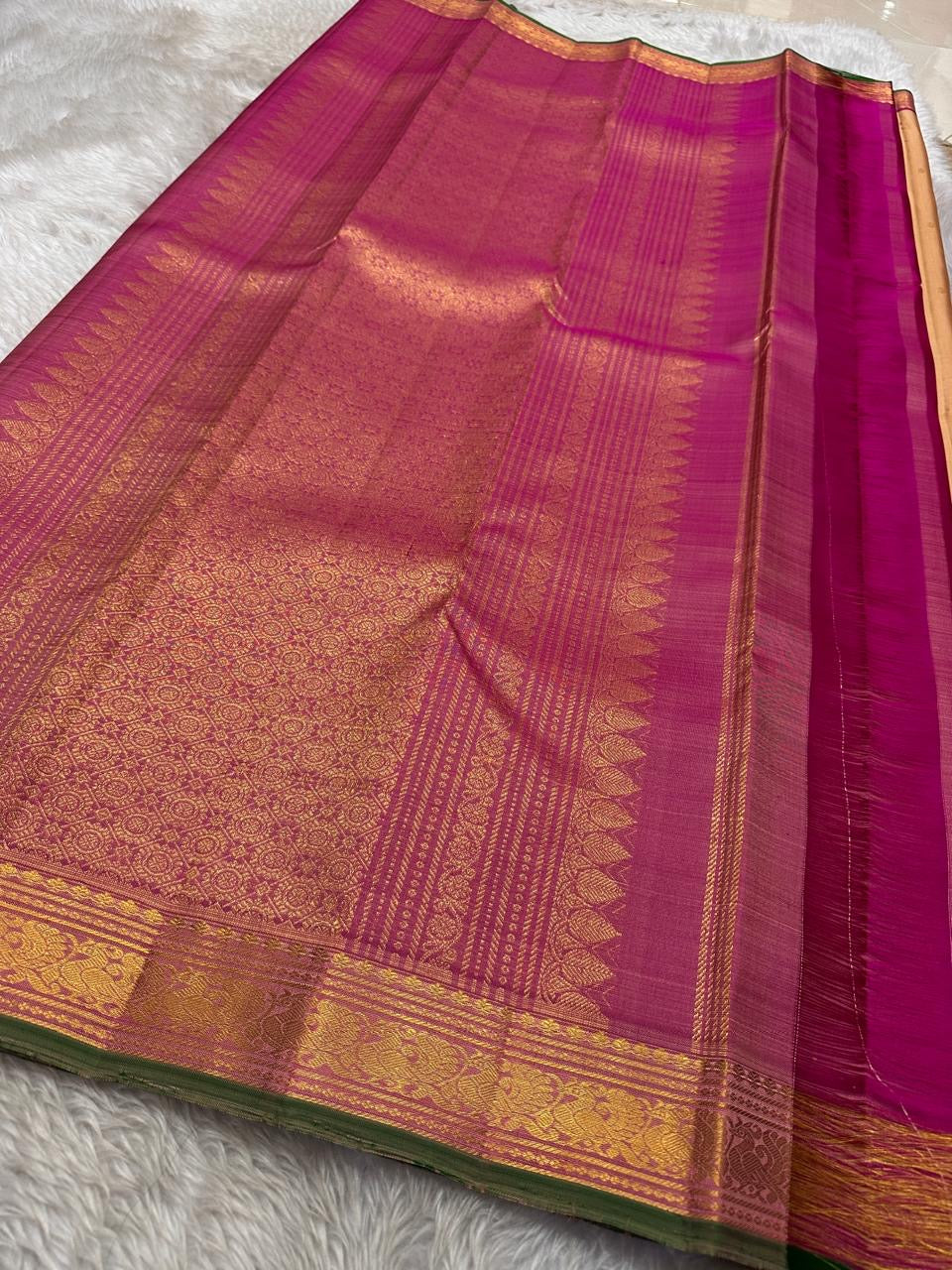 Pure silk kanchipuram Biscuit beige  color body with zari buttas , magenta mayil border with green selvedge