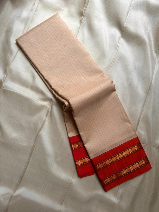 Sharvani Red– Cream Checked Silk Saree with Red Orange shot color Zari Border & Vibrant Pallu
A timeless silk saree featuring a cream body with delicate red checks, complemented by a striking red zari border pallu.