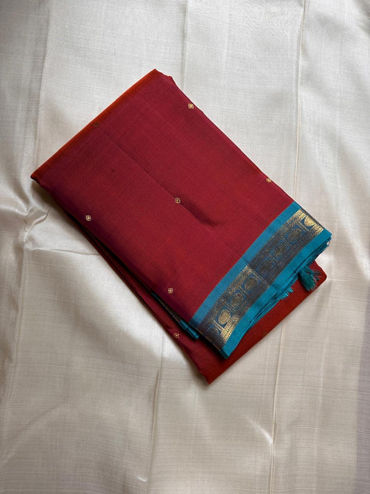 Komethagam Rama ✨
Pure Kanchipuram Silk Saree in Ember Red & Rāmar Blue
Ember-red body with gold zari buttas – gemstone inspired
Contrast Rāmar-blue border with chakra & vine motifs

Silk Mark Certified, delivery in 2 weeks
