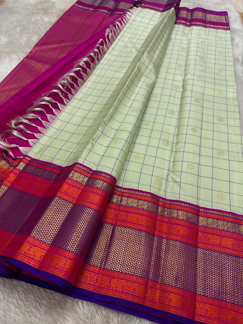 Pastel green pistachio with kungumam red and royal blue border dark blue silk thread checks mayil chakram butta magenta detailed Pallu