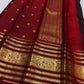 Close view of fine vertical zari filaments and gold buttas on deep plum Kanchipuram silk
