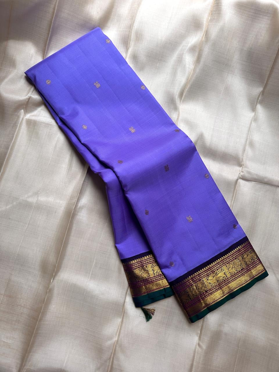 Kili kanchipuram beautiful purple and violet combination adorned with kili and kamalam butta , vanasringaram border and green selvedge with parrots parading   in Pallu