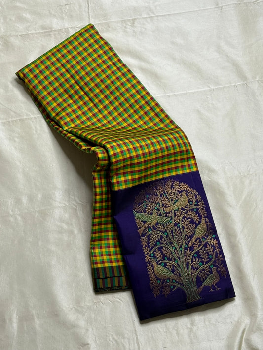 Vriksham ✨
Pure Kanchipuram Silk Saree in Multicolor Checks & Purple
kattam body in yellow, green, red & Rama blue
Royal purple border with zari Tree-of-Life & birds

Silk Mark Certified, delivery in 2 weeks