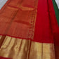 Full spread emerald green Kanchipuram silk saree with red border and grand gold zari pallu
