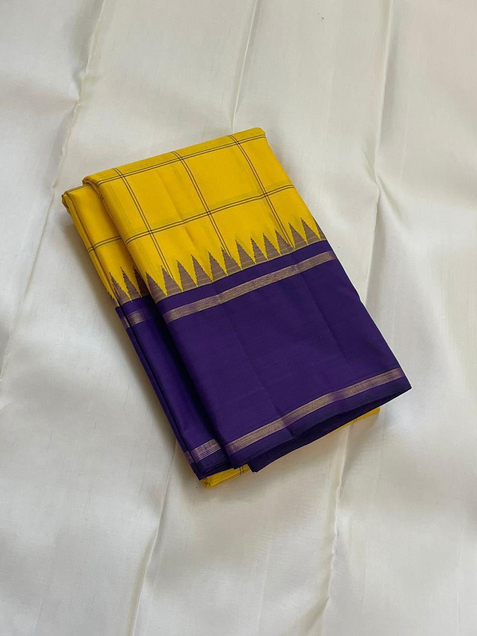 Haldi Violet Kattam Korvai
Pure Kanchipuram Silk Saree – Bright Haldi Yellow Checks with Contrasting Violet Korvai Borders
Minimal zari lines for an elegant look
Grand violet pallu with delicate zari stripes, silk mark certified, ships in 2 weeks