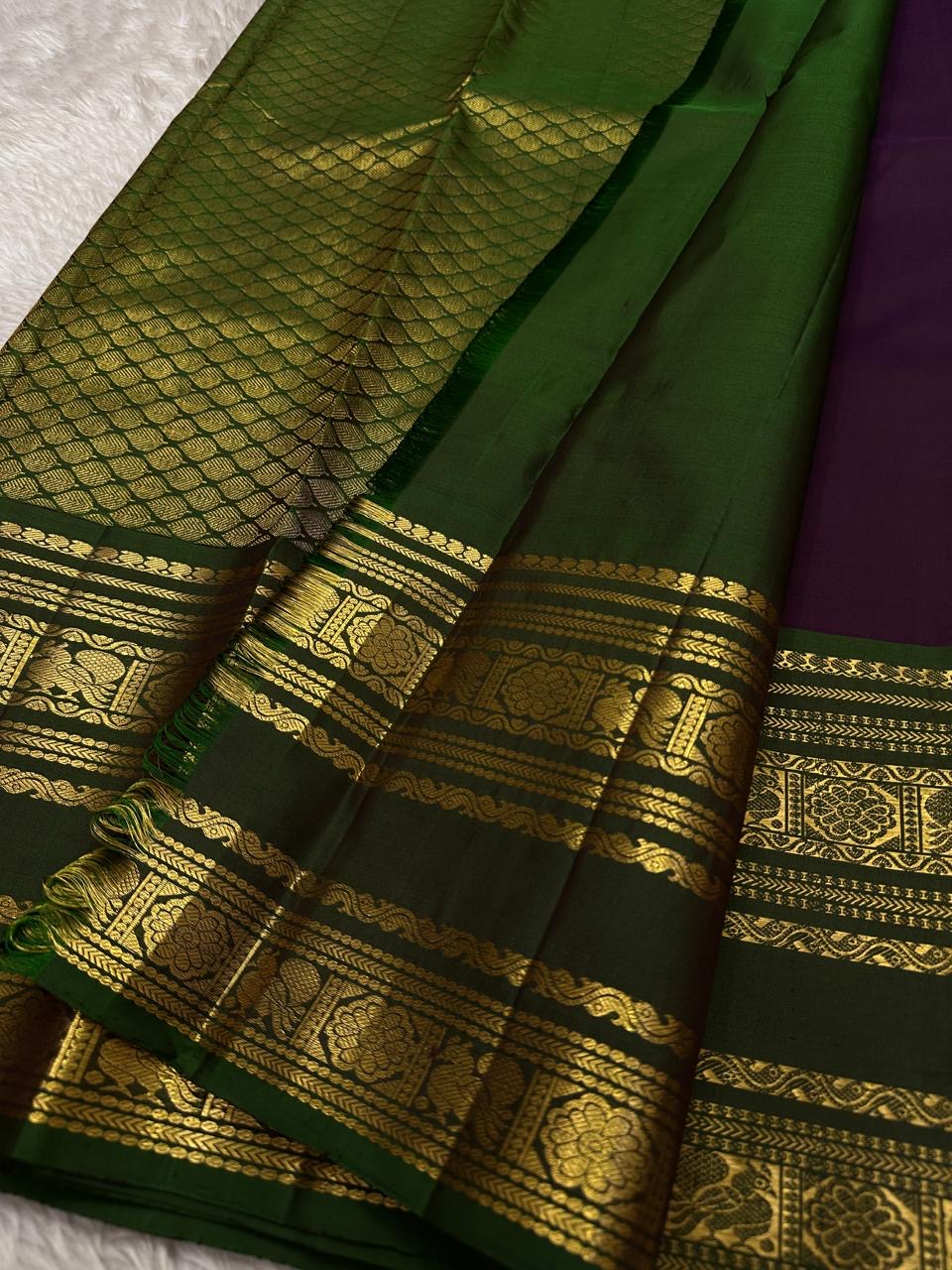 Radhe ✨
Plum Purple Oosi-Striped Kanchipuram Silk
Zari-Woven Yaali Motifs on the Body
Bottle-Green Rettapet Border with Peacocks
Grand Gold Zari Jaal Please | Silk Mark Certified