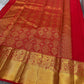 A traditional Kanjivaram (Kanchipuram) silk saree, vibrant red orange peacock floral motifs bavanji border and ornate grid motif Pallu