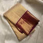 Ragini – Ivory & Gold Kanchipuram Pure Silk Saree with Floral Jaal & Maroon Baavanji Border
Timeless elegance shines through the delicate ivory base and shimmering gold zari floral jaal. The rich maroon Baavanji border and intricate pallu details complete