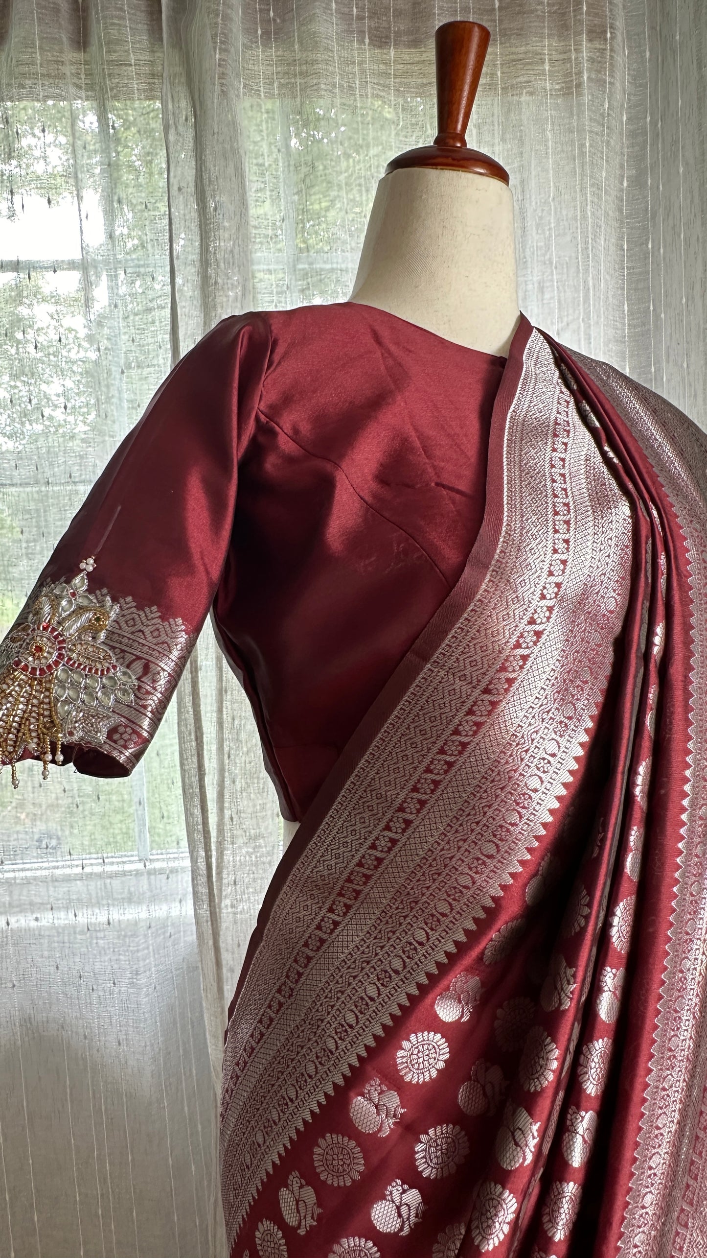 Maroon silver and gold Saree with peacock motif embroidery embellished with temple jewelry style stone work