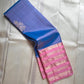 Ramyam, meaning pleasant and delightful, features a mesmerizing blue–purple shot body that shimmers with every movement. Its radiant pink korvai border and pallu, adorned with traditional Varisaipet zari stripes, add festive brilliance.silk mark certified