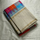 Venpattu Kattam Thazampoo Reku – ivory/venpattu borders with multicolor kattam (checks) body

Pure Kanchipuram silk • rani pink, tangerine, purple, sky blue & steel grey checks with thazampoo reku edging

Ivory pallu with gold tissue stripes & multicolor