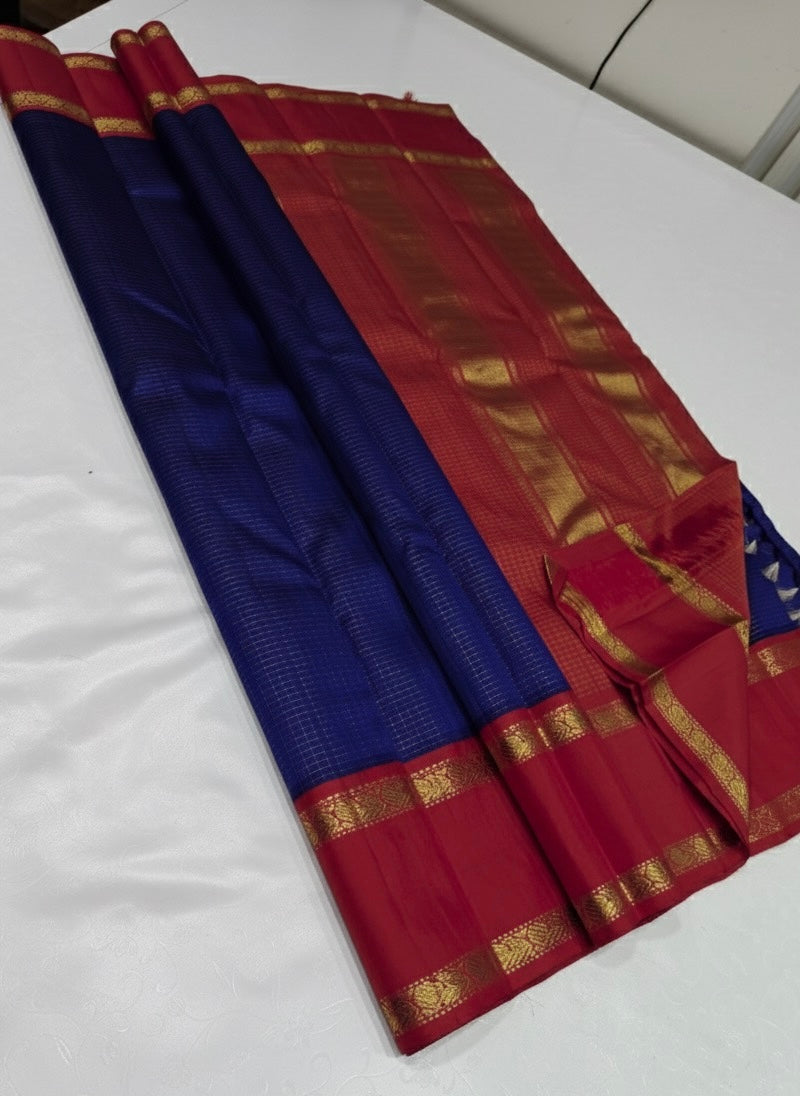 💎 Sapphire Rouge Oosi Kattam — Pure Kanchipuram Silk Saree
Royal sapphire-blue body with fine oosi-kattam checks and contrast rouge-red borders in antique-gold zari
Silk Mark Certified • Free Shipping within USA • Ships in Two Weeks •