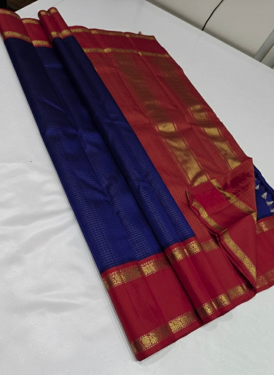 💎 Sapphire Rouge Oosi Kattam — Pure Kanchipuram Silk Saree
Royal sapphire-blue body with fine oosi-kattam checks and contrast rouge-red borders in antique-gold zari
Silk Mark Certified • Free Shipping within USA • Ships in Two Weeks •