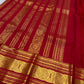 Vermilion Podi Kattam 🌺 Pure Silk Kanchipuram Saree

All-over zari pinstripes & mini podi kattam checks ✨

Broad antique-gold borders with chakram medallions 🪙

Silk Mark Certified ✅ | F