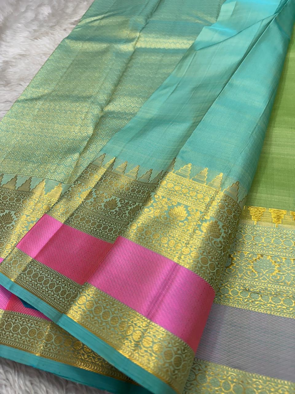 Rose pistachio meadow  – Pure Silk Kanchipuram Saree
Pista Green Body with Coin Paving Mayil Zari Buttas 🦚
Borders in Aqua & Rose with Pillayar Moggu Motifs ✨
Grand Aqua Pallu in All-Over Zari Brocade Weave
Silk Mark Certified | ships in 2 weeks