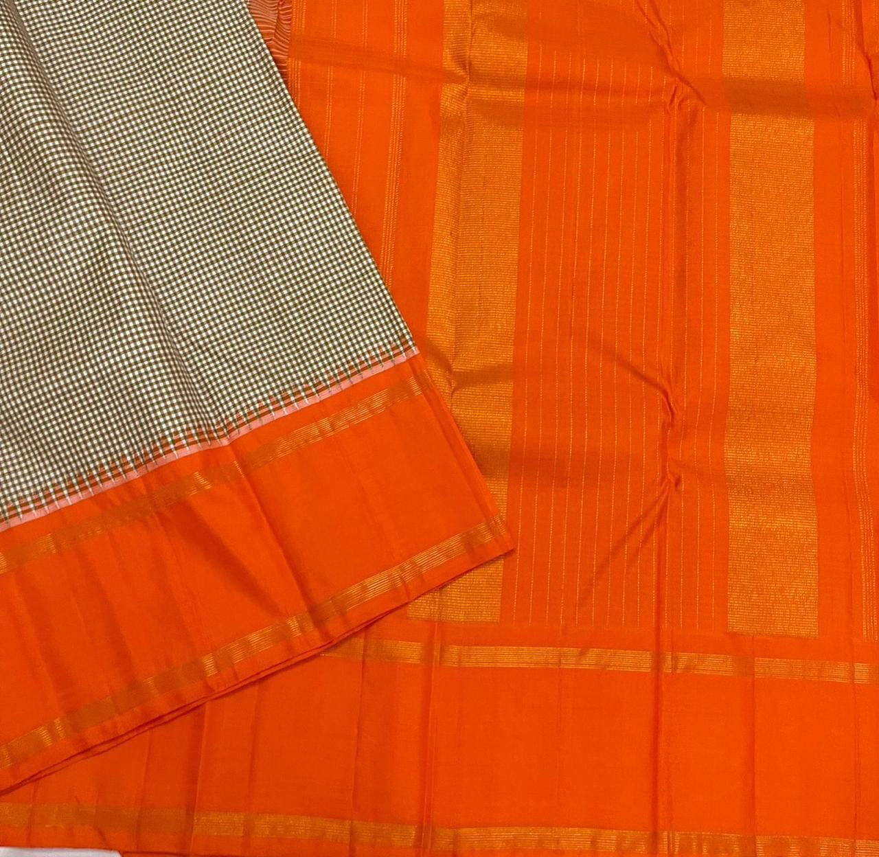 Rust Kattam Korvai – Pure Silk Kanchipuram Saree
Olive–Ivory Micro-Checks Body with Korvai Join
Rust Orange Border
Rust Orange Pallu pillayar Reku
Comes with Matching Rust Orange Blouse Piece with Zari Border silk mark certified - ships in 2 weeks