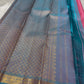Varnam – Pastel Pink Kanchipuram Silk Saree with Sky Blue Rudraksha Border & Grid Zari Pallu | Baby Kamalam Buttas | Pure Handloom Elegance