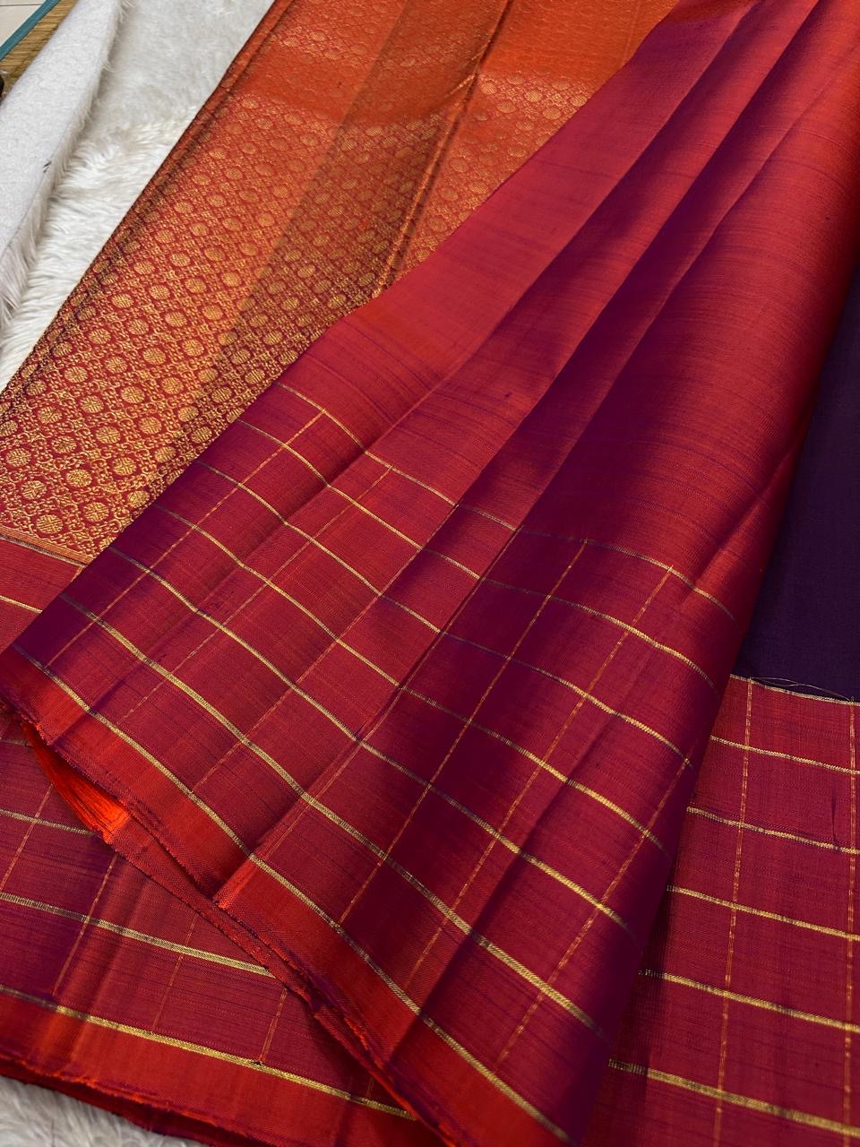 Poornima Kalyani
Deep Purple & Vermilion Kanchipuram Silk Saree
Zari Buttas · Checkered Borders · Silk Mark Certified